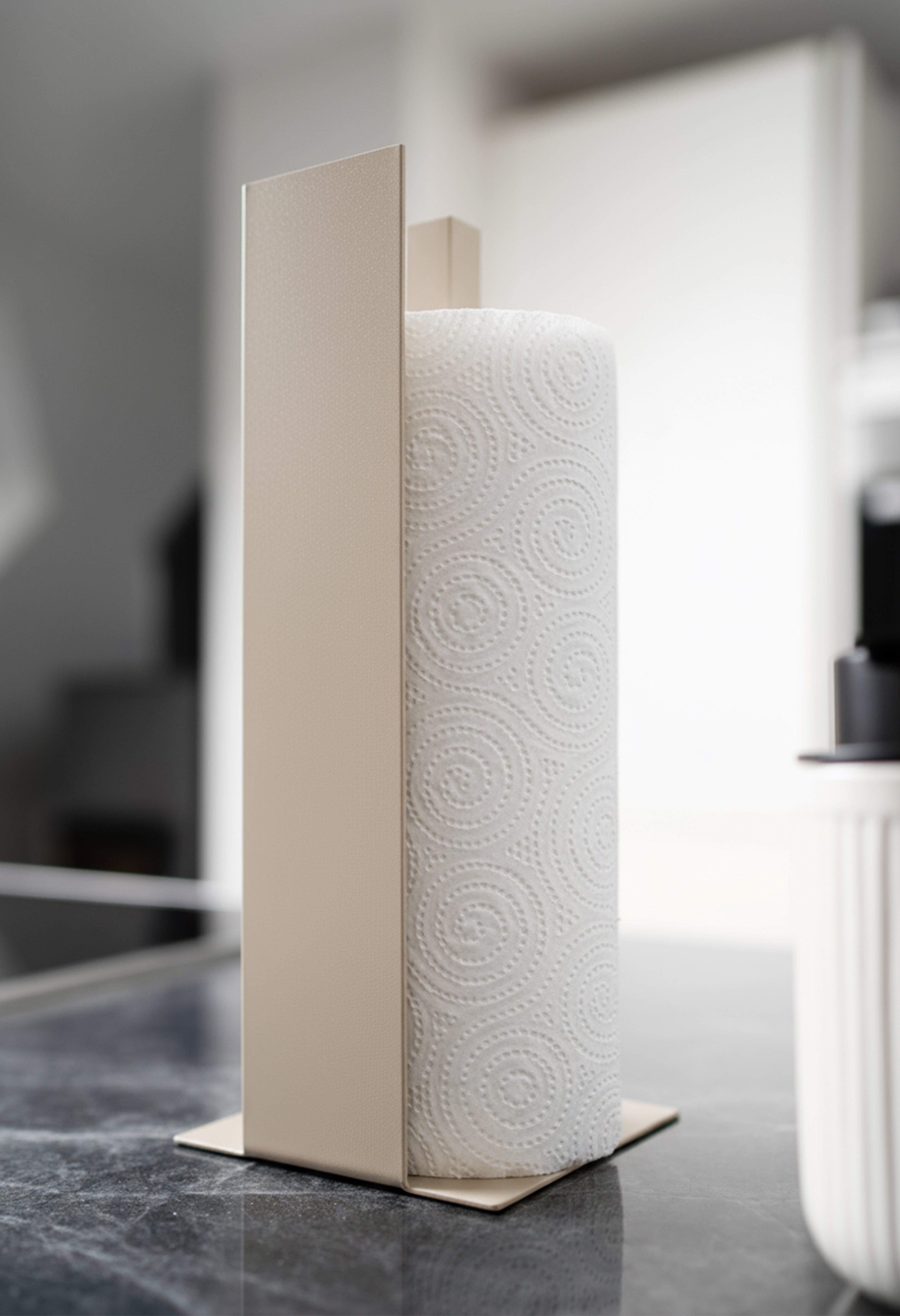 Küchenrollenhalter Granada pulverbeschichtet in matt beige auf einer dunklen Marmorarbeitsfläche in einer hellen Küche