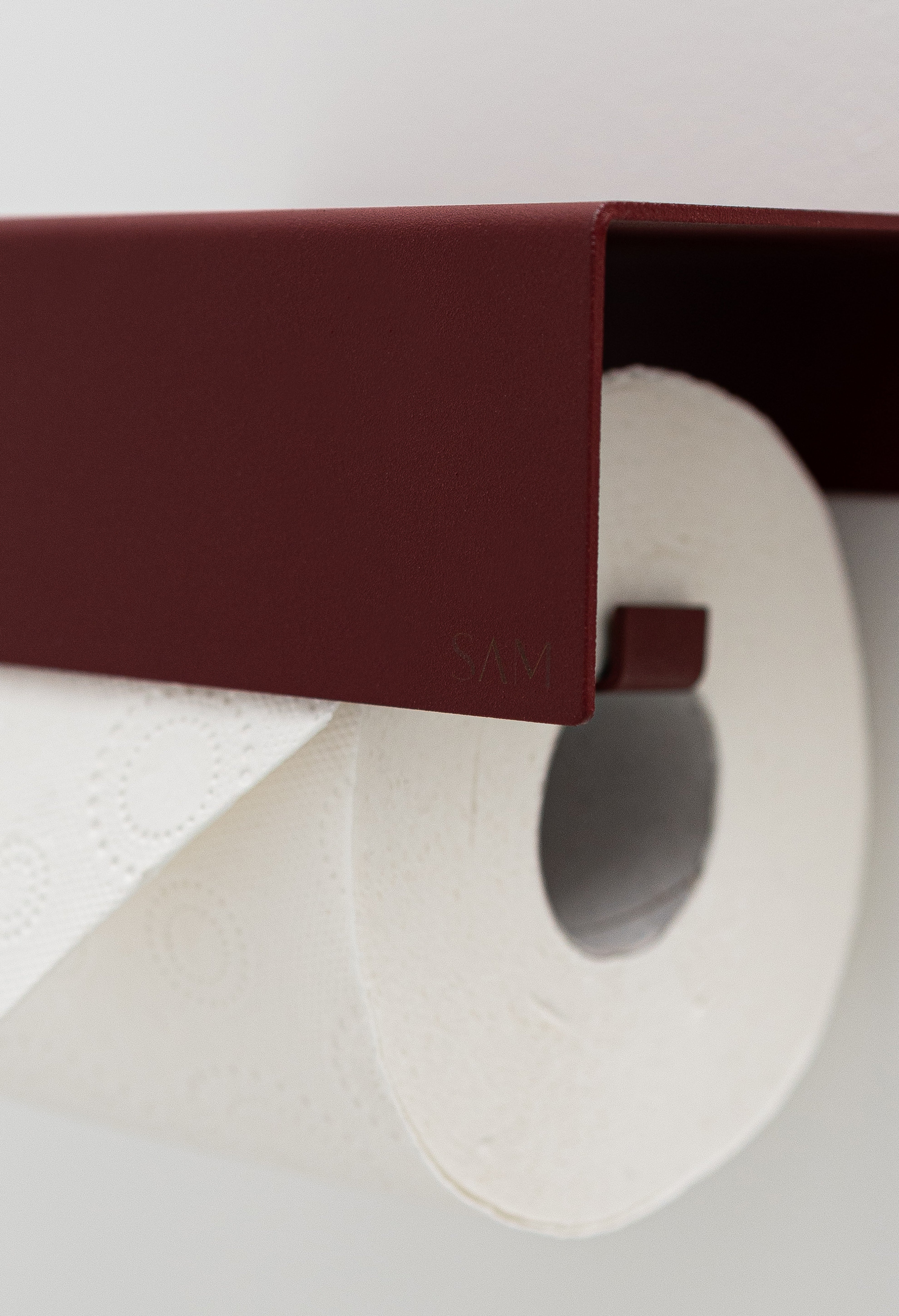Toilettenpapierhalter LILLE zum Kleben ohne Bohren in Farbe Velvet Red. Close-Up Pulverbeschichtung und gelsertes SAM Logo